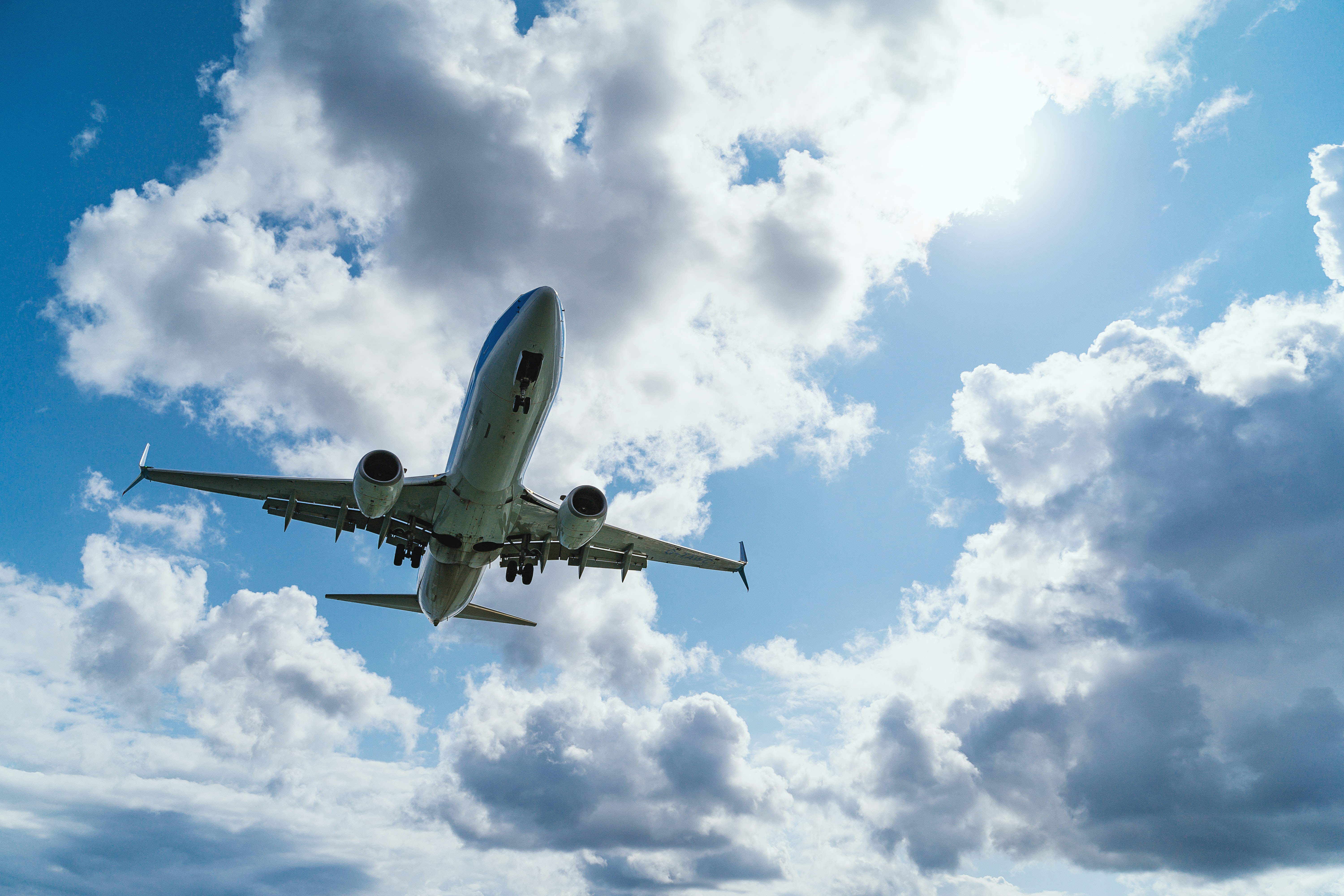 low-angle photography of airliner during flight flying with vape gear