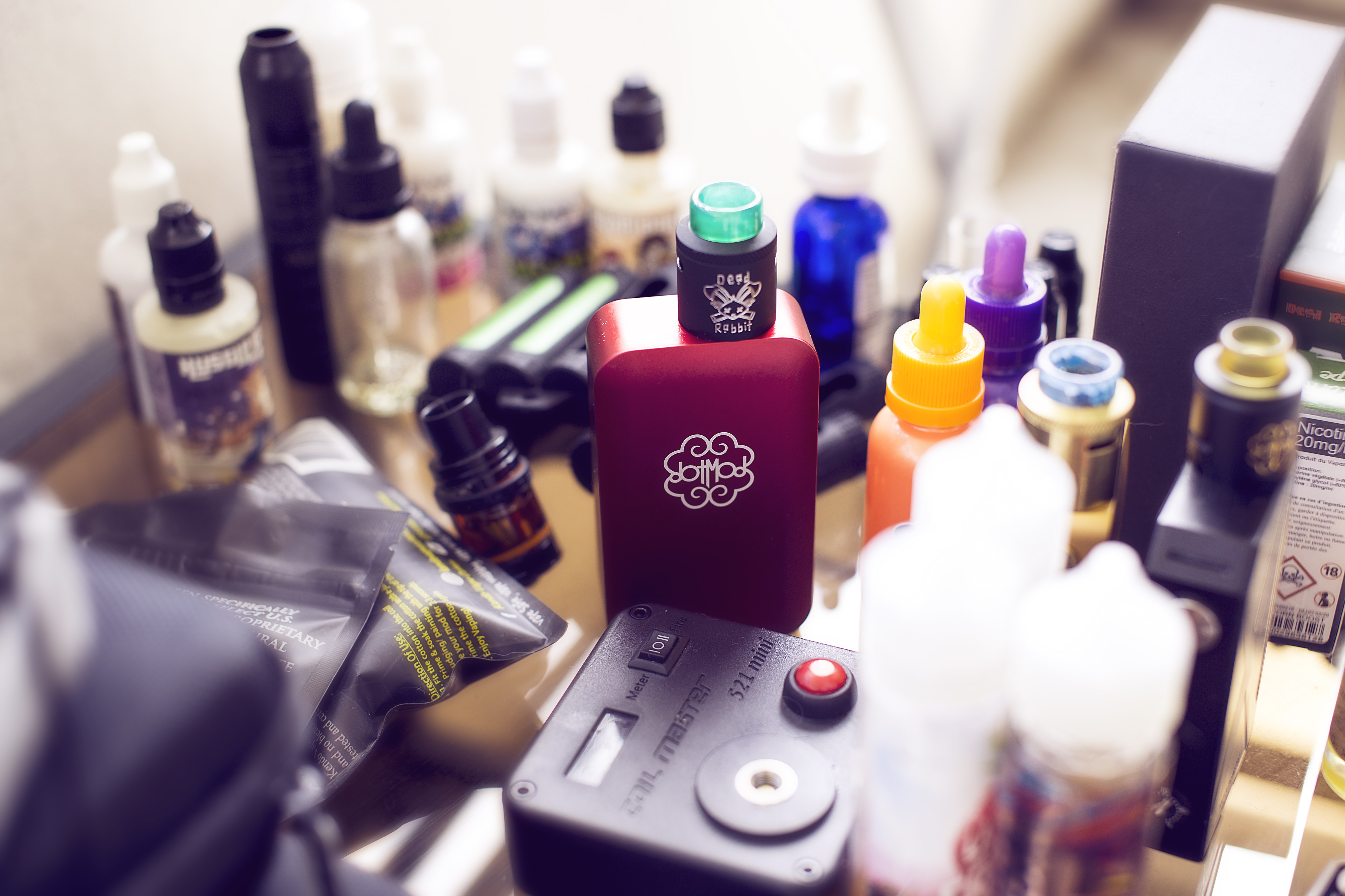 red box mod vape beside e-juice bottles - The Future Of Vaping