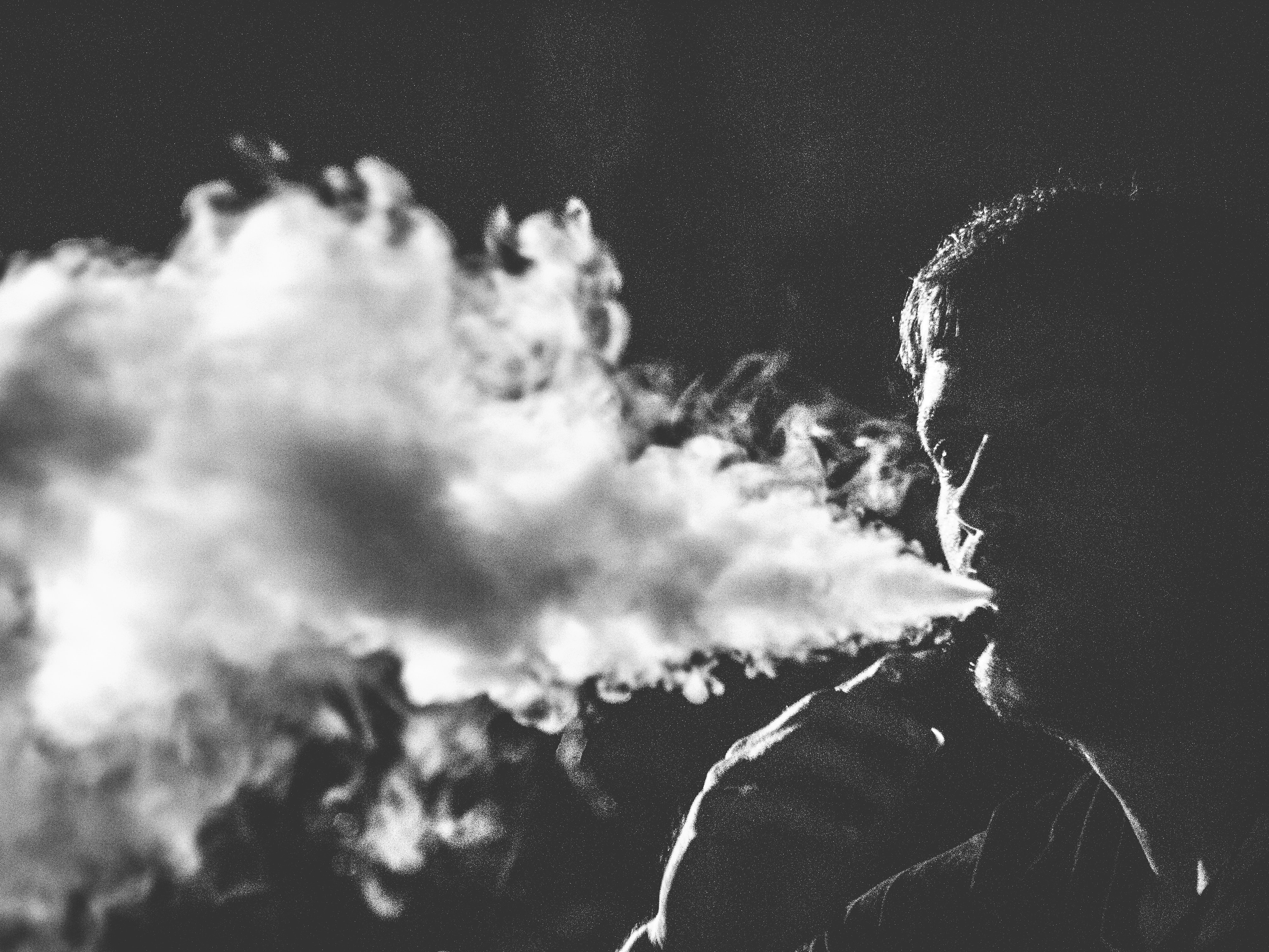 grayscale photography of vaping Best Vape Juice Brands